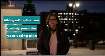 A still frame from a video. A Black woman stands outside in the late evening or early morning. Teal boxes with white lettering appear next to her reading "MichiganDropBox.com can help you make your voting plan."